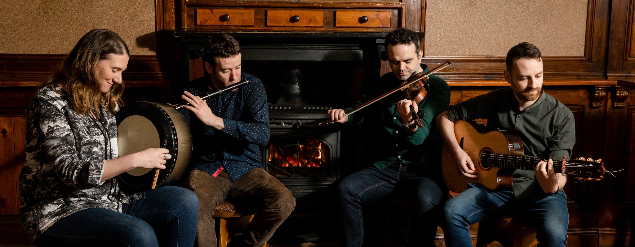 Ox Mountain Quartet performing together by the fireplace